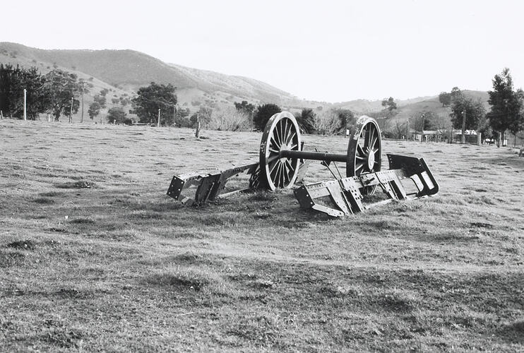 Iron frames and large wheels from remnants of an early steam locomotive.