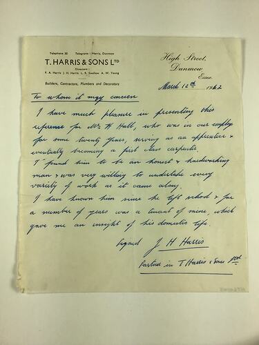 White page with black printed letterhead. Handwritten text in blue ink.