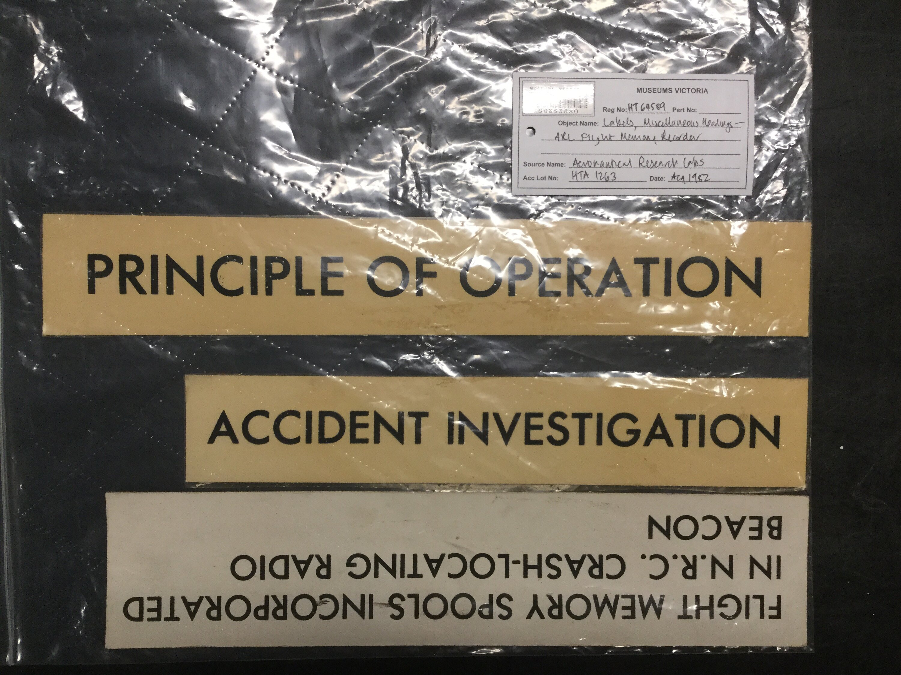 A collection of white labels with black text identifying an ARL Flight Memory Recorder.