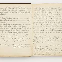Open book with off white ruled pages. Handwritten text.