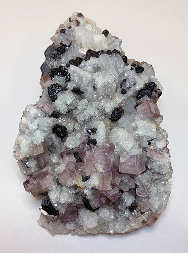 Pinky-purple, square crystals growing with white, tapioca-like crystals.