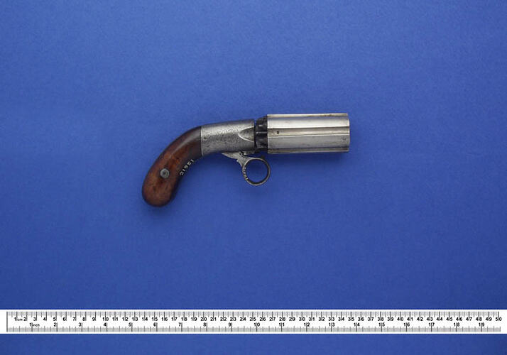 Metal revolver with a wooden handle.