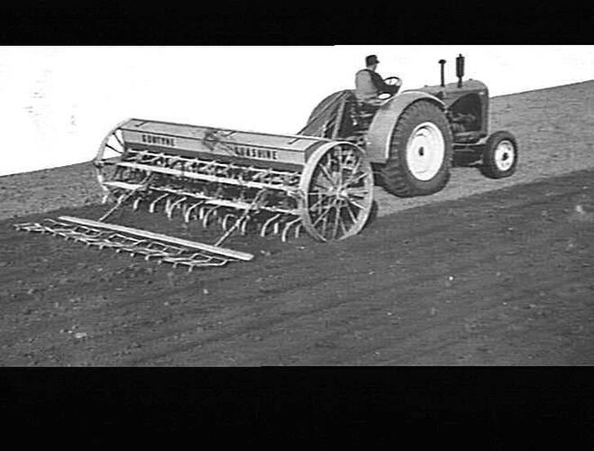 A photograph of a farmer tilling his land.