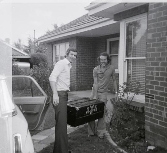 Digital Photograph - Two Men Carrying Trunk from Front Door, Moving House, Balwyn North, 1974