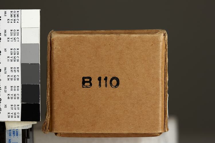 Brown cardboard box, black text, for paper tape.