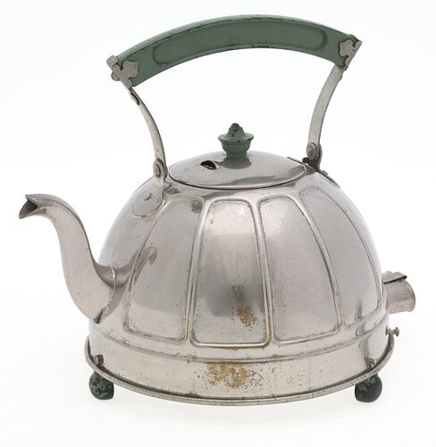 Domed stainless steel kettle. The bakelite handle grip and three feet are painted green.