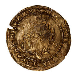 Coin, round, Edward VI enthroned facing holding a sword and orb; below, tudor rose partly removed from die.