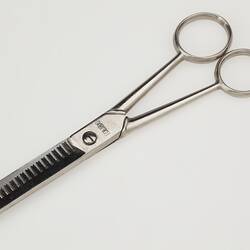 Scissors for hairdressing with special toothed blade.