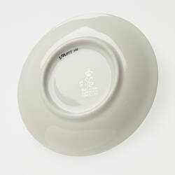 White china saucer with imprint.