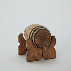 Round wooden barrel with tap on stand.