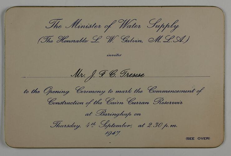 Rectangular buff-coloured card with blue printed cursive text and gilt edging.