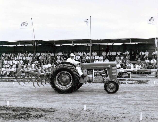 Tractors on display in front of grandstand.