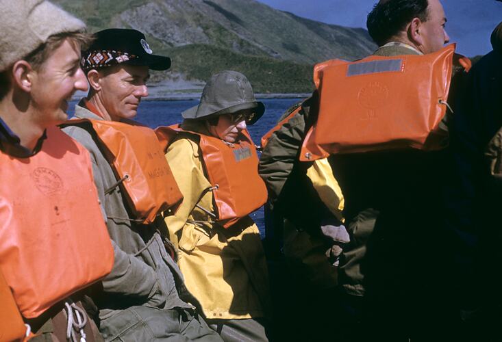 Group of people wearing life jackets.