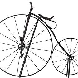 Iron bicycle painted black with large front wheel and small rear wheel. Seat on large front wheel.