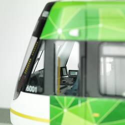 Tram model of articulated, low-floor tram. Detail (external) of driver's green and white compartment.