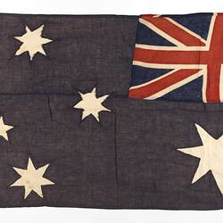 Reverse of faded Australian flag with horizontal seam at centre.