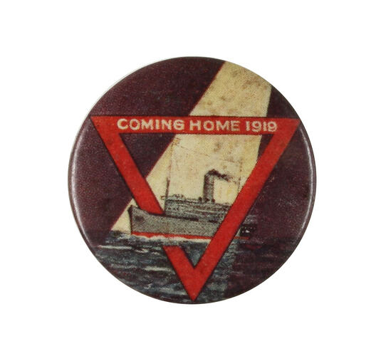 Front of badge with red triangle and photo of ship.