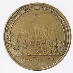 Round gold medal with scene of a naval battle. Text around.