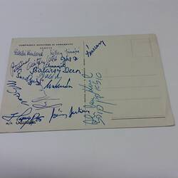 Postcard with signatures at left.