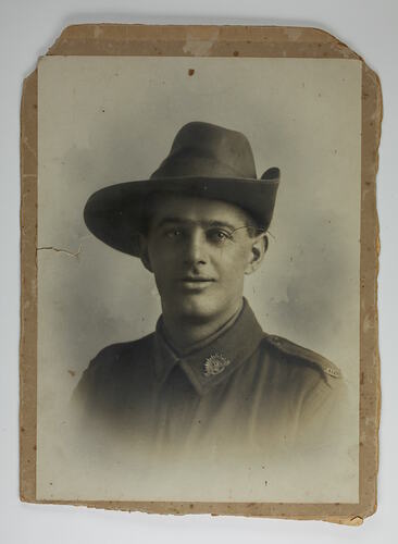 Head and shoulders portrait of soldier mounted on cardboard.