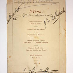 Printed menu showing food and signatures.
