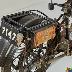 Motor cycle, right rear view angle. Number plate and satchel.