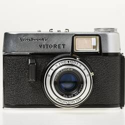 Black camera, metal trim and lens with text around. Flash top left corner.