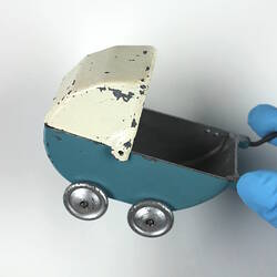 Blue and white toy pram.