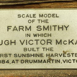Closeup of label on farm smithy model.