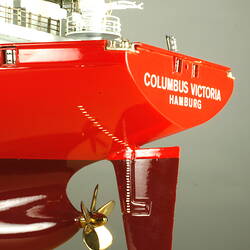 Container ship with red hull, detail of rear.