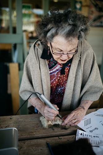 Aunty Jennine Armistead Etching Art on Possum Skin, Frankston