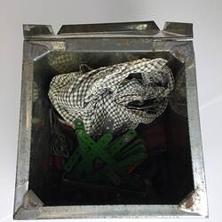 Inside tin containing all construction pieces.