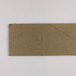 Plain back of a brown exhibition label.