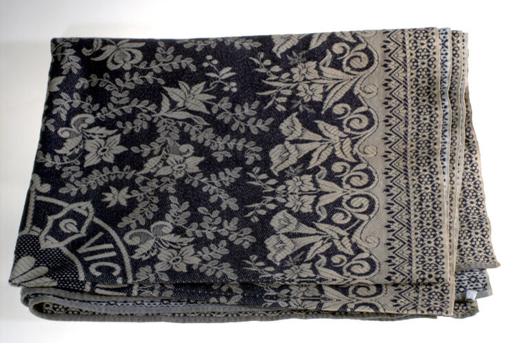 Black and cream floral petterned rug.
