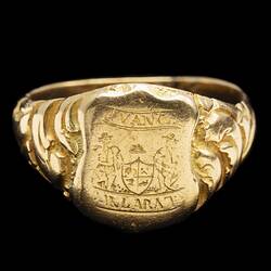 Large gold ring with central shield design featuring the words "Advance Ballaarat" and two miners leaning on a coat of arms.