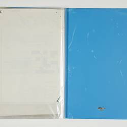 Open blue folder. Blank left white page. Blue folder back cover on right.