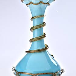 Pale blue opaque glass vase with gilded ribbon spiralling from base up to top. Flared neck with frill at top.