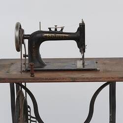 Detail of sewing machine fitted to a metal frame.