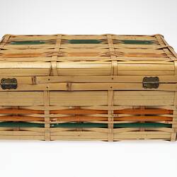 Cane basket, hinge lid. Orange and green stripe detail. Back.