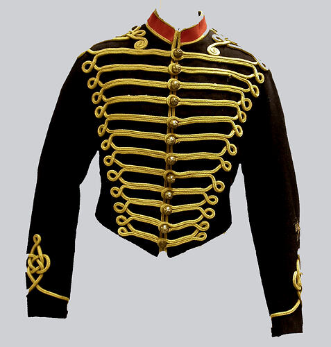 Black military jacket with red collar and extensive gold-coloured cotton braid frogging in front,