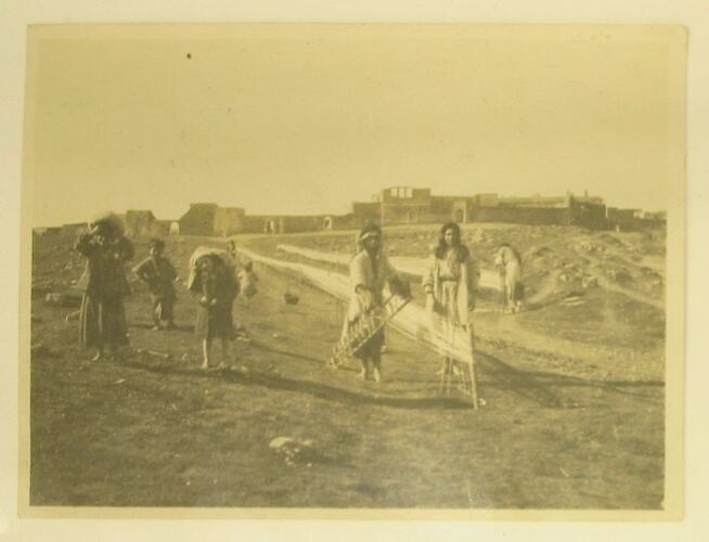 Women drying yarn in field in Mosul.