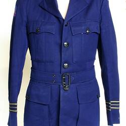 Navy jacket, two breast pockets and two hip pockets. Cloth belt with buckle.