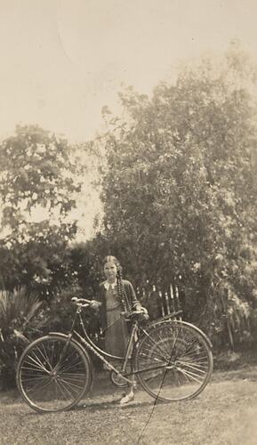 Digital Photograph - Girl in Braids Standing with Bicycle in Garden, Colac, 1936