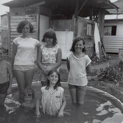 Digital Photograph - One Boy and Five Girls in Circular Wading Pool, Backyard, Ringwood East, 1965