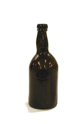 Dark bottle, asymmetry reveals hand made.