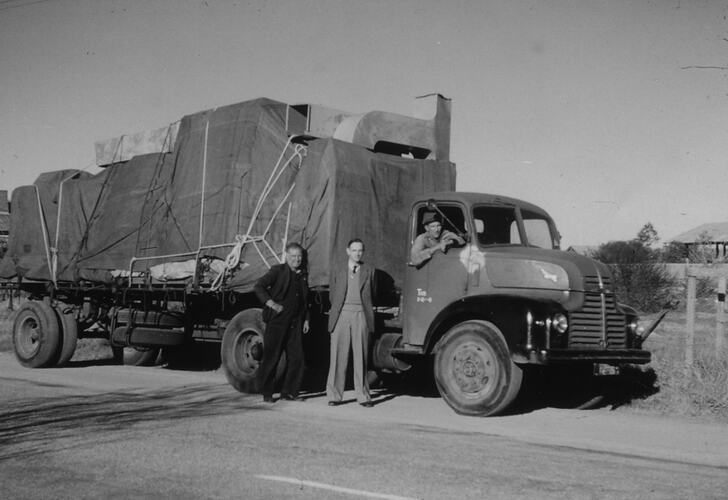 Fully laden truck, two men and driver.