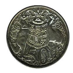 Round silver coin with impression of kangaroo and emu either side of shield.