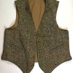 Brown and mustard yellow waistcoat, one button missing.