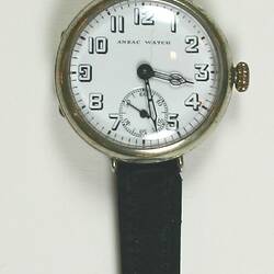 Watch, circular white dial, skeleton Arabic numerals, brown leather bands.