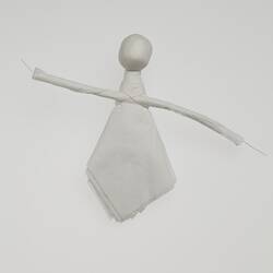 Doll made out of white paper.